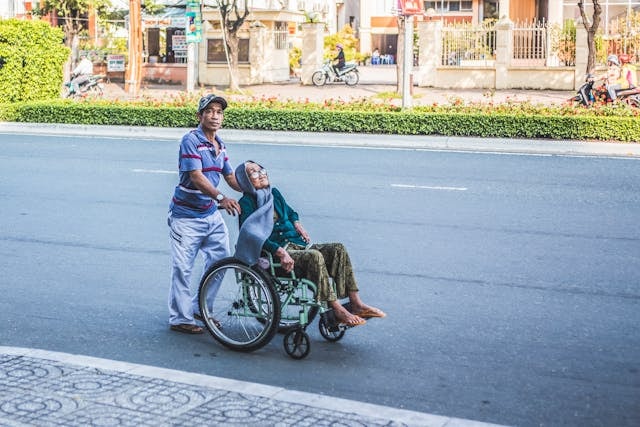 man-pushing-a-woman-sitting-on-wheelchair