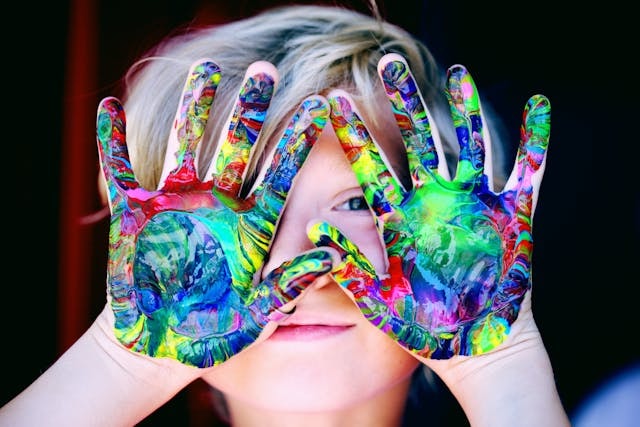 a-kid-with-multicolored-hand-paint