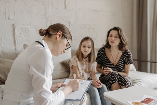 doctor-in-a-consultation-with-a-mother-and-her-daughter