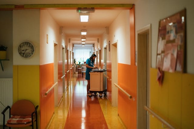 nurse-with-cart-on-corridor-at-hospital