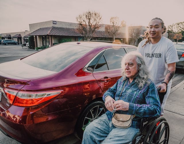 a-man-pushing-a-wheelchair-on-the-street