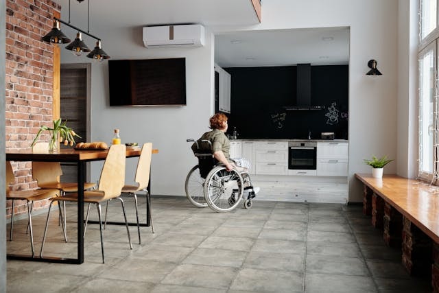 photo-of-woman-on-wheelchair-going-to-the-kitchen