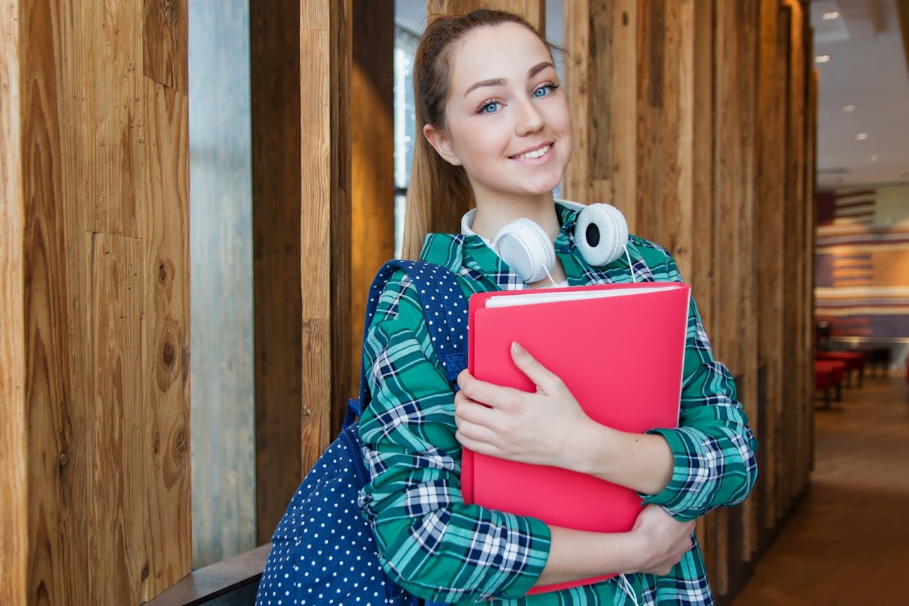 woman-standing-in-hallway-while-holding-book