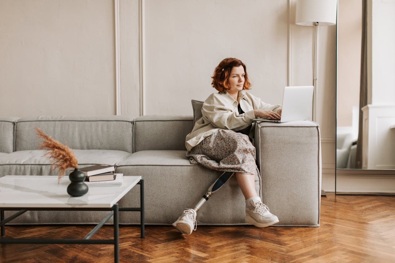 woman-sitting-on-a-sofa-using-laptop