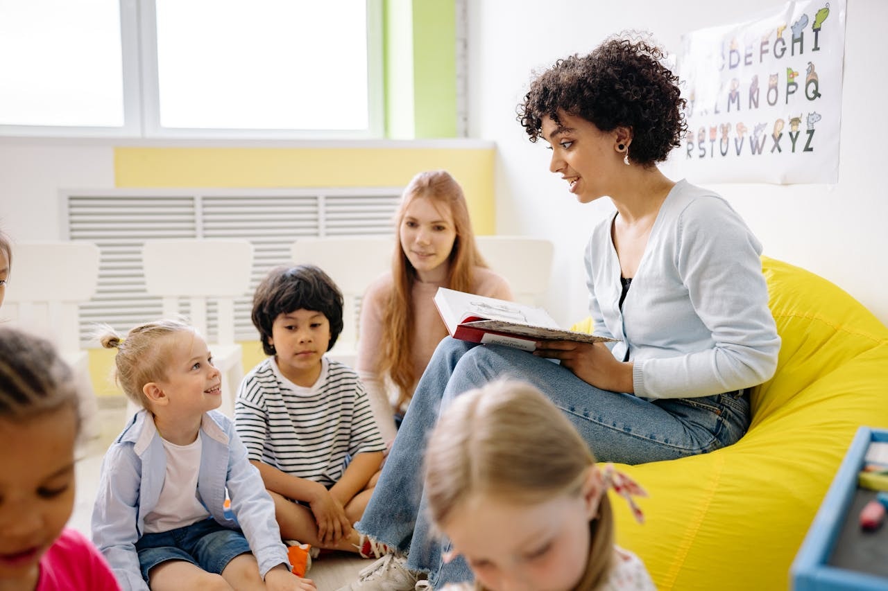 a teacher reading a book for kids